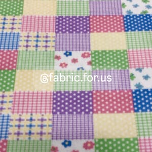 May include: A patchwork fabric with a variety of patterns in pink, green, purple, blue, and yellow. The patterns include polka dots, plaid, and floral designs.