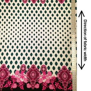 May include: A white fabric with a black background and a repeating pattern of teal and black diamonds. The fabric has a pink and black floral border with intricate designs. The fabric is 58 inches wide.