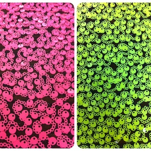 May include: Two fabric swatches with a repeating pattern of round sequins. The fabric on the left is pink and the fabric on the right is green.