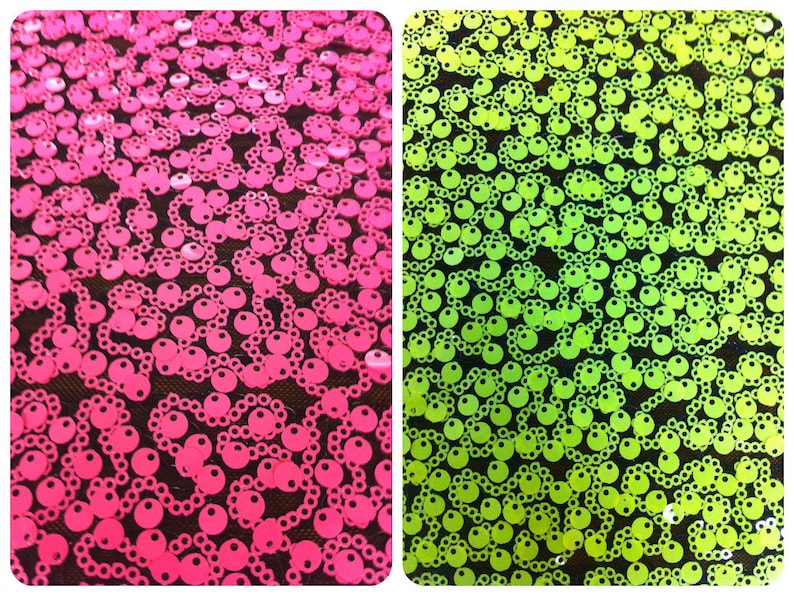 May include: Two fabric swatches with a repeating pattern of round sequins. The fabric on the left is pink and the fabric on the right is green.
