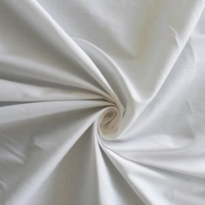 May include: White fabric with a smooth texture, folded and twisted into a spiral shape.