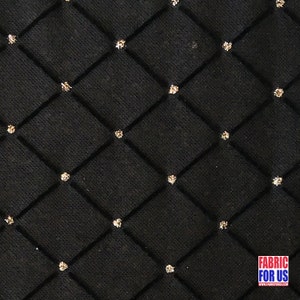 May include: Black fabric with a diamond pattern and gold glitter accents.