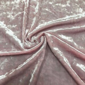 May include: A close-up of a soft, pink crushed velvet fabric with a subtle sheen. The fabric is folded and draped, showcasing its texture. The text "CV-BLUSH" is visible in the top centre of the image.
