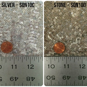 May include: Close-up of two fabric swatches with silver and stone colored sequins. A penny is placed on each swatch for scale. The swatches are labeled "SILVER - SQN 10C" and "STONE - SQN 100D". A ruler is placed below the swatches with markings from 10 to 12 inches.