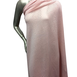 May include: Pink mesh fabric with a small square pattern. The fabric is draped over a mannequin.