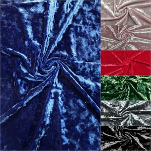 May include: A close-up of crushed velvet fabric in a variety of colours, including blue, pink, red, green, and grey. The fabric has a soft, luxurious feel and is perfect for crafting projects.