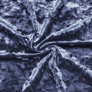 May include: Close-up of a blue crushed velvet fabric with a subtle sheen. The fabric is textured and has a soft, luxurious feel. The text "CV-Slate Blue" is visible in the top centre of the image.
