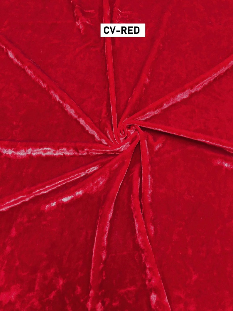 May include: A close-up of a deep red velvet fabric with a soft, plush texture. The fabric is folded and draped, showcasing its luxurious feel.