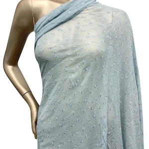 May include: Light blue sheer fabric with a delicate white floral embroidery pattern.