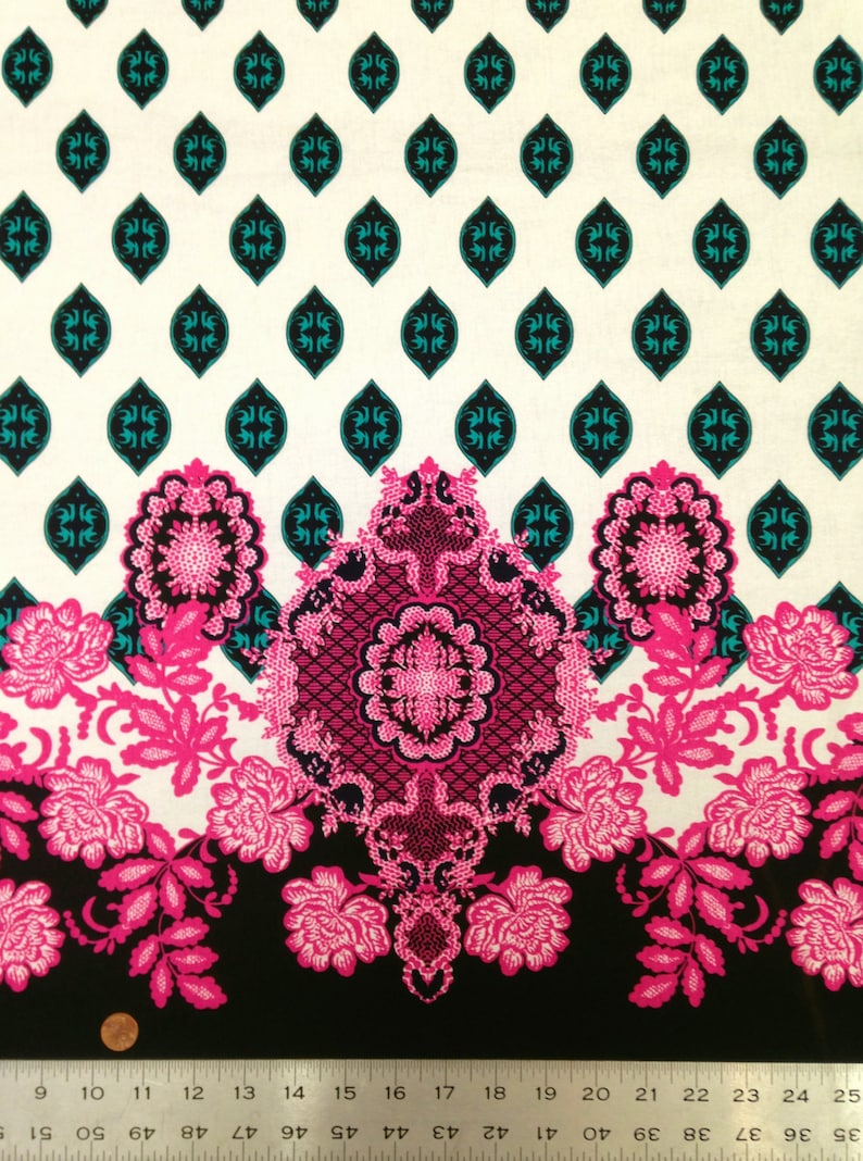 May include: A white fabric with a repeating pattern of teal blue diamonds. The fabric has a border of pink and black floral designs.