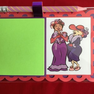 May include: A red notepad with a green sticky note and a pencil. The notepad has a decorative border with a scalloped edge. The sticky note is blank. The pencil is pink and white with gold stripes. The notepad has a picture of two women in hats laughing. The women are wearing purple and blue dresses.