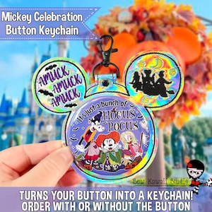 May include: A holographic Mickey-shaped button keychain featuring Goofy, Minnie Mouse, and Daisy Duck dressed as the Sanderson sisters. The text reads "Amuck Amuck Amuck" and "It's just a bunch of Hocus Pocus" with silhouettes of three witches flying on a broomstick.