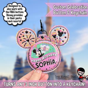 May include: A custom celebration keychain with a pink Mickey Mouse design. The keychain features the text "Happy Birthday SOPHIA" and is designed to turn a 7.6 cm button into a keychain. The background is a blurred image of a Disney park.