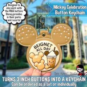 May include: A tan, Mickey-shaped faux leather keychain holder with a metal lobster clasp. The center features a circular graphic with the text "BEIGNET ALL DAY" and illustrations of three Mickey-shaped beignets and a drink with a straw.