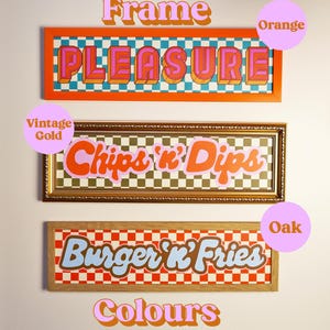 May include: Three framed wall art pieces with retro-style text. The top frame is orange with "PLEASURE" in pink and orange. The middle frame is gold with "Chips 'n' Dips". The bottom frame is oak with "Burger 'n' Fries".