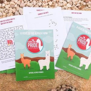 May include: A collection of children's activity sheets and booklets. The booklets feature the text "A Visit to the Alpaca Farm" and the logo for "Carolina Pride Pastures". The sheets include a maze, connect-the-dots, and math problems.