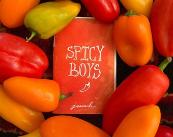 May include: A red card with the text "Spicy Boys" in white lettering. The card is surrounded by red and orange peppers.