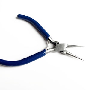 May include: Pliers with blue handles and long, pointed tips. These pliers are used for jewellery making.