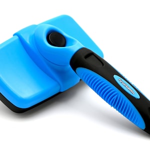 May include: Blue and black pet grooming brush with a black button and a handle that says "FursuitSupplies".