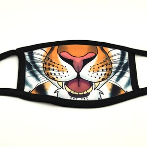 May include: Black fabric face mask with a tiger's mouth printed on it. The mouth is open and shows teeth and a pink tongue.