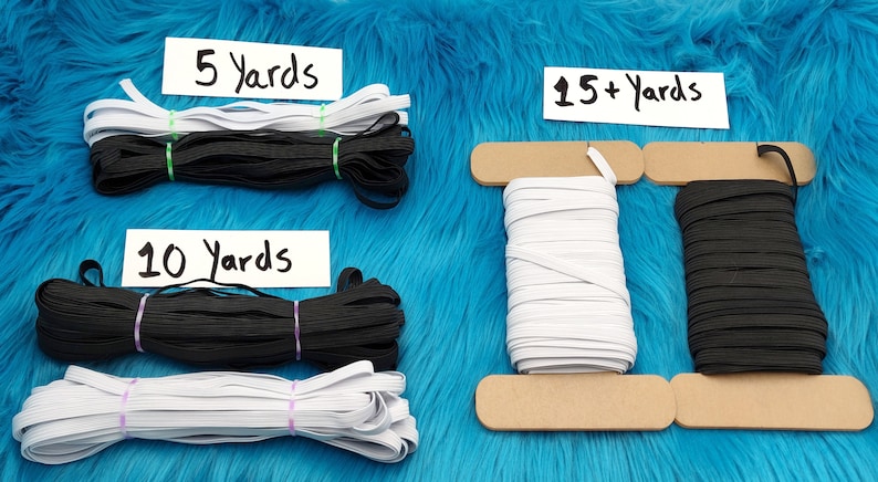 May include: White and black elastic cord spools in various lengths, including 5 yards, 10 yards, and 15+ yards. The spools are on a blue fuzzy surface.
