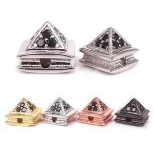 May include: Five pyramid-shaped beads with black cubic zirconia stones. The beads are available in gold, silver, rose gold, and black.