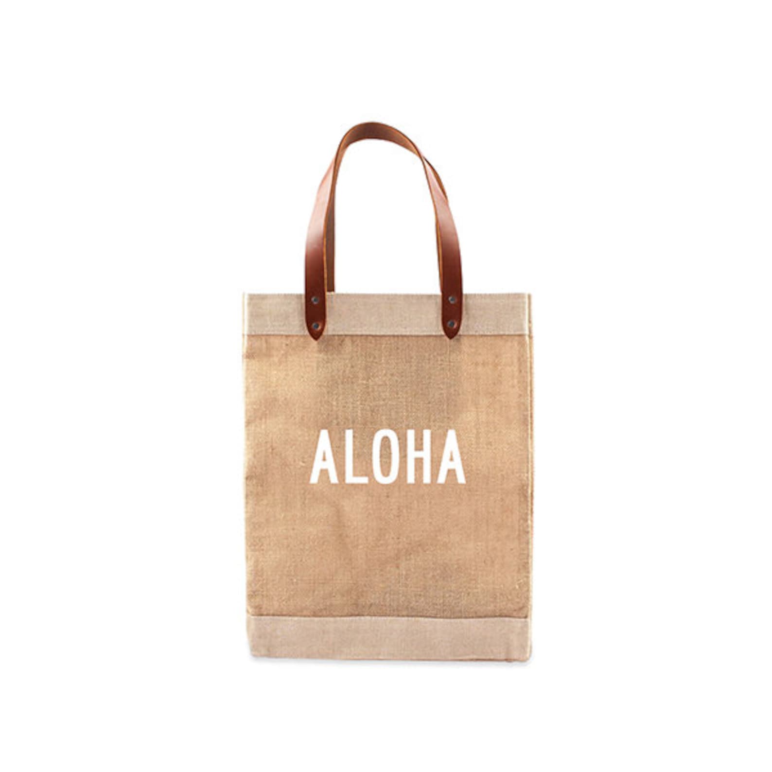 Brown shopping bag with white Aloha lettering, perfect for buying local groceries such as tropical fruit jams, tea and macadamia nuets