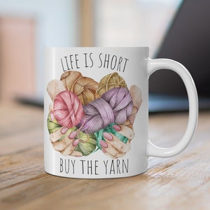 May include: White ceramic mug with a black and white graphic of yarn balls and the text "Life is short, buy the yarn".