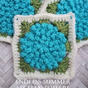 May include: Close-up of a crocheted square with a blue center, green border, and white outer border. The text "Endless Summer Afghan Square Crochet Pattern" is below the square.