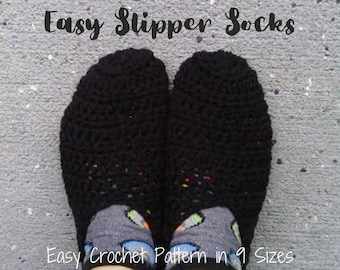 May include: Black crochet slipper socks with the text "Women's Quick and Easy Slipper Socks". The socks are shown on a person's feet, with patterned socks visible underneath. The text "Easy Crochet Pattern in 9 Sizes" is also visible.