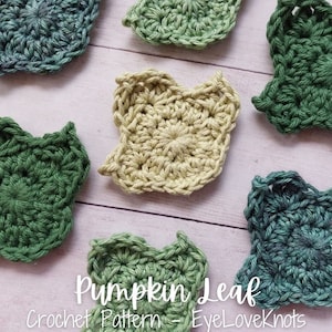 May include: Five crocheted pumpkin leaf squares in various shades of green and yellow. The squares are arranged on a white wooden surface. The text "Pumpkin Leaf Crochet Pattern - EyeLoveKnots" is written below the squares.