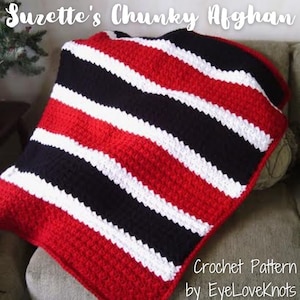 May include: A red, white, and black striped crochet afghan. The crochet pattern is called "Suzette's Chunky Afghan" and is by EyeLoveKnots.