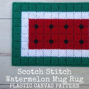 May include: A rectangular plastic canvas craft featuring a Scotch stitch pattern in the shape of a watermelon slice. The design includes a dark green border, a white inner border, and a red center with black dots. Text reads: Scotch Stitch Watermelon Mug Rug PLASTIC CANVAS PATTERN.