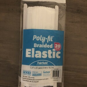 May include: A package of white Poly-fil braided elastic. The blue label reads "Poly-fil Braided Elastic" and includes the dimensions: 0.24" x 20 yards (6 mm x 18.2 m). The package is sealed in clear plastic.