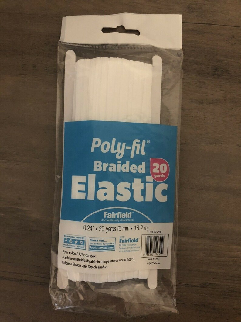 May include: A package of white Poly-fil braided elastic. The blue label reads "Poly-fil Braided Elastic" and includes the dimensions: 0.24" x 20 yards (6 mm x 18.2 m). The package is sealed in clear plastic.
