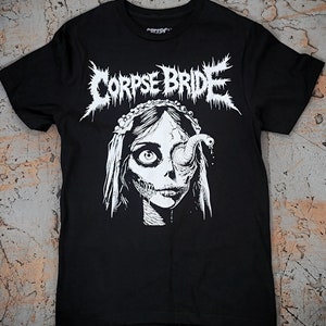 May include: Black t-shirt with a white graphic of a woman with a worm coming out of her eye. The text "CORPSE BRIDE" is above the woman's head in a metal font.