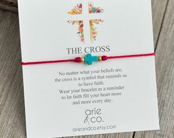 May include: A red string bracelet featuring a small turquoise cross bead and two gold-tone accent beads, displayed on a white card with a floral cross graphic, the text THE CROSS, and an inspirational message by arie & co. arieandco.etsy.com.