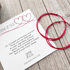 May include: Two red string bracelets with a card that reads "Red String of Fate" and a poem about an invisible red thread connecting those who are destined to meet. The card also includes the text "arie & Co. arieandco.etsy.com"