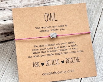 May include: A pink string bracelet with a silver owl charm. The card attached to the bracelet reads "OWL. The wisdom you seek is already within you. Tie this bracelet on your wrist, close your eyes and make a wish, when this bracelet breaks in two, the wish you made might just come true. ASK BELIEVE RECEIVE arieandco.etsy.com"