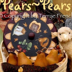 May include: A white wicker basket filled with brown pears, with a brown and white fabric covering the top. The basket has a round lid with a painted design of a star, a house, a bow, and a pear. The text "Pears~Pears" and "Copyright by Terrye French" is visible on the image.