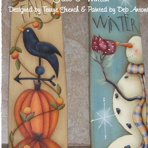 Puede incluir: Dos barriles de madera pintados, uno representando una escena de otoño con un pájaro negro, una calabaza y hojas, y el otro representando una escena de invierno con un muñeco de nieve y un pájaro rojo. El texto "Fall & Winter" está escrito en la parte superior de los barriles.
