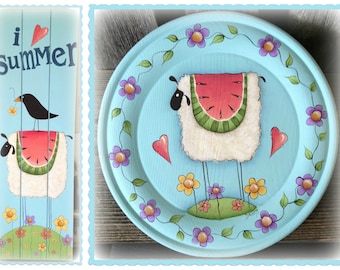 May include: A painted wooden plate with a blue background and a white sheep wearing a watermelon. The sheep is standing on a green patch of grass with yellow and purple flowers. The plate is decorated with a vine of green leaves and purple flowers.