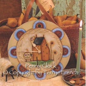 May include: A hand-painted wooden clock with a blue and white design. The clock face features a house with a red roof and a sunflower. The clock is surrounded by a wreath of sunflowers and the words "Penny Clock" and "Copyright by Terrye French".