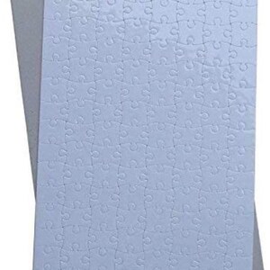 May include: A light blue jigsaw puzzle with interlocking pieces, resting on a gray backing. The puzzle is a solid color, and the pieces are clearly defined. The image is a top-down view of the puzzle.