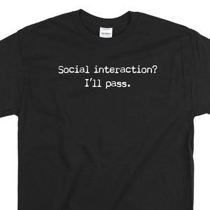 May include: Black t-shirt with white text that reads "Social interaction? I'll pass."