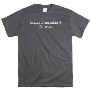 May include: A dark grey t-shirt with the text "Social interaction? I'll pass." printed in white.