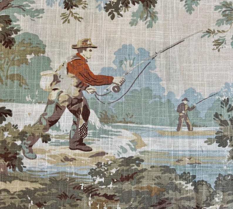May include: A vintage fabric featuring a scene of two people fishing in a river. The fabric has a light beige background with green and blue foliage and a light blue river. One person is wearing a red shirt and a hat, while the other person is wearing a brown shirt and a hat. Both people are holding fishing rods.