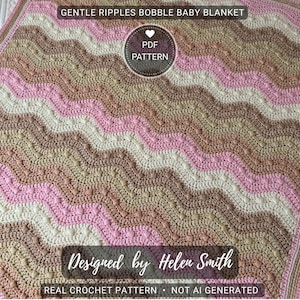 May include: A handmade baby blanket with a bobble stitch design. The blanket features a wavy pattern in shades of pink, white, and tan. The text "GENTLE RIPPLES BOBBLE BABY BLANKET" and "Designed by Helen Smith" are visible.
