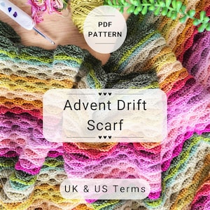 May include: A colorful, textured scarf in shades of pink, yellow, green, and purple. The scarf is crocheted with a wavy pattern. The image also shows a crochet hook, yarn, and the text "Advent Drift Scarf" and "UK & US Terms".