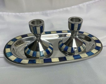 May include: Two silver candle holders with blue and white inlay designs, sitting on a silver tray with a matching blue and white inlay design.
